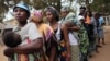 FILE - Angolans queue at a voting station in Kicolo, Luanda, Angola to cast their ballots, Aug. 31, 2012. 