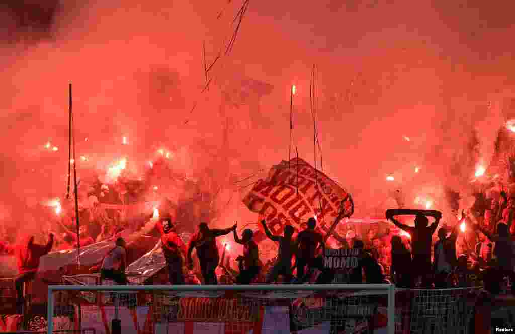 Supporters light fireworks prior to the Europa League group H soccer match between 1.FC Koeln and Crvena zvezda Belgrade at the Muengersdorfer stadium in Cologne, Germany.
