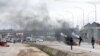 Policemen shoot canister of tear gas to disperse people during a demonstration and attacks against South Africa's owned shops in Abuja, Nigeria, Sept. 4, 2019.