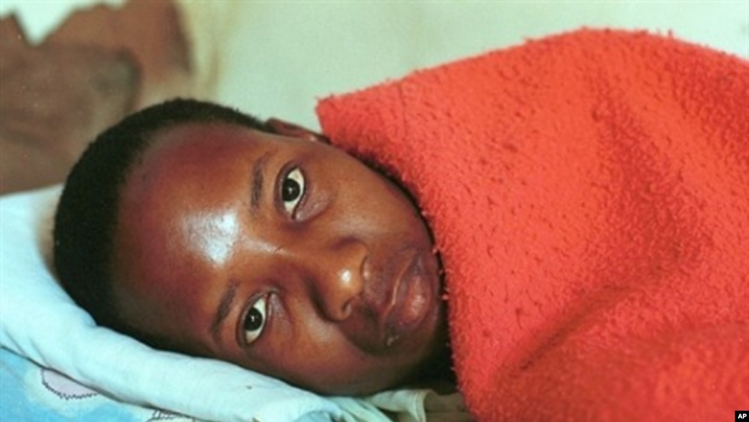 25-year-old South African, Lawrence Jet who is HIV-positive lies on his bed (file photo)