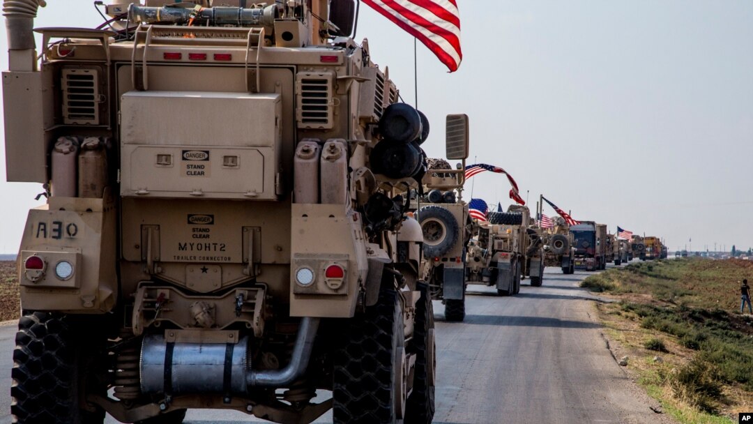 FILE - U.S. military convoy drives near the town of Qamishli, northern Syria, Oct. 26. 2019. 