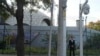 A plainclothes security person stand watch outside the Israeli Embassy in Beijing, Oct. 13, 2023. 