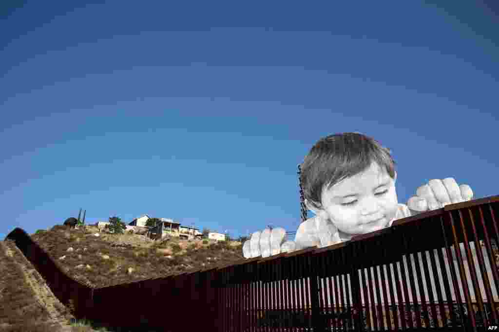 View of an artwork by French artist JR on the U.S.-Mexico border in Tecate, California, Sept. 6, 2017.