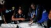 Ghana counts votes in tight presidential race, hopes for better times