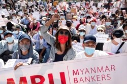 FILE - Demonstrators rally outside the Central Bank of Myanmar during a protest against the military coup and to demand the release of elected leader Aung San Suu Kyi, in Yangon, Myanmar, Feb. 11, 2021.