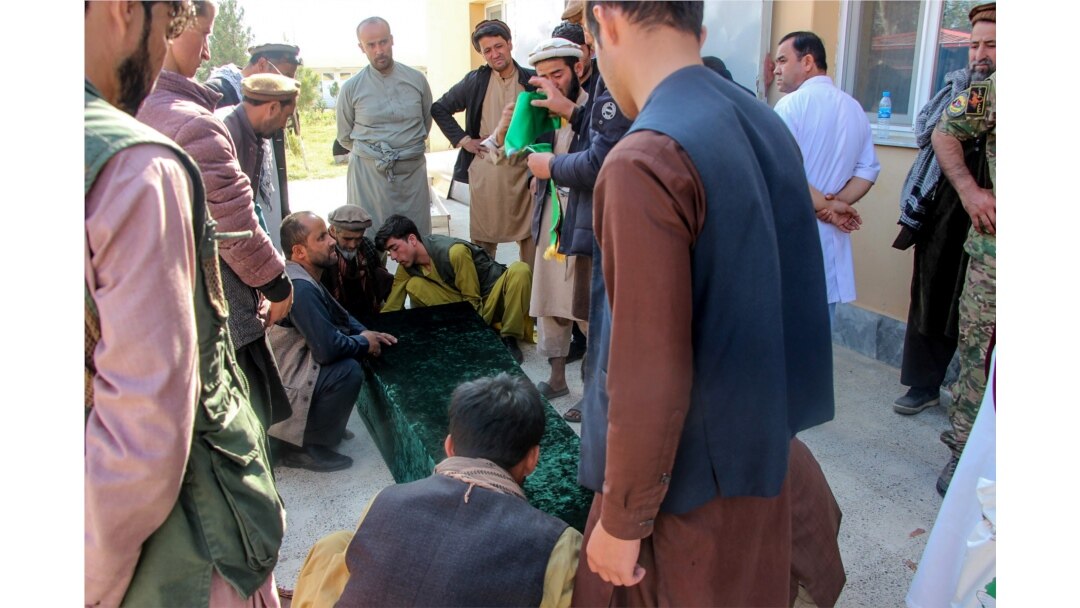 FILE - Relatives gather next to the coffin of a soldier after an ambush blamed on the Taliban killed at least 25 Afghan security force personnel as spiraling violence imperils ongoing peace talks, in Takhar province, Oct. 21, 2020. (AFP)