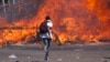 Zimbabwe's opposition supporters set up a burning barricade as they clash with police during a protest for electoral reforms, Aug. 26, 2016 in Harare, Zimbabwe.