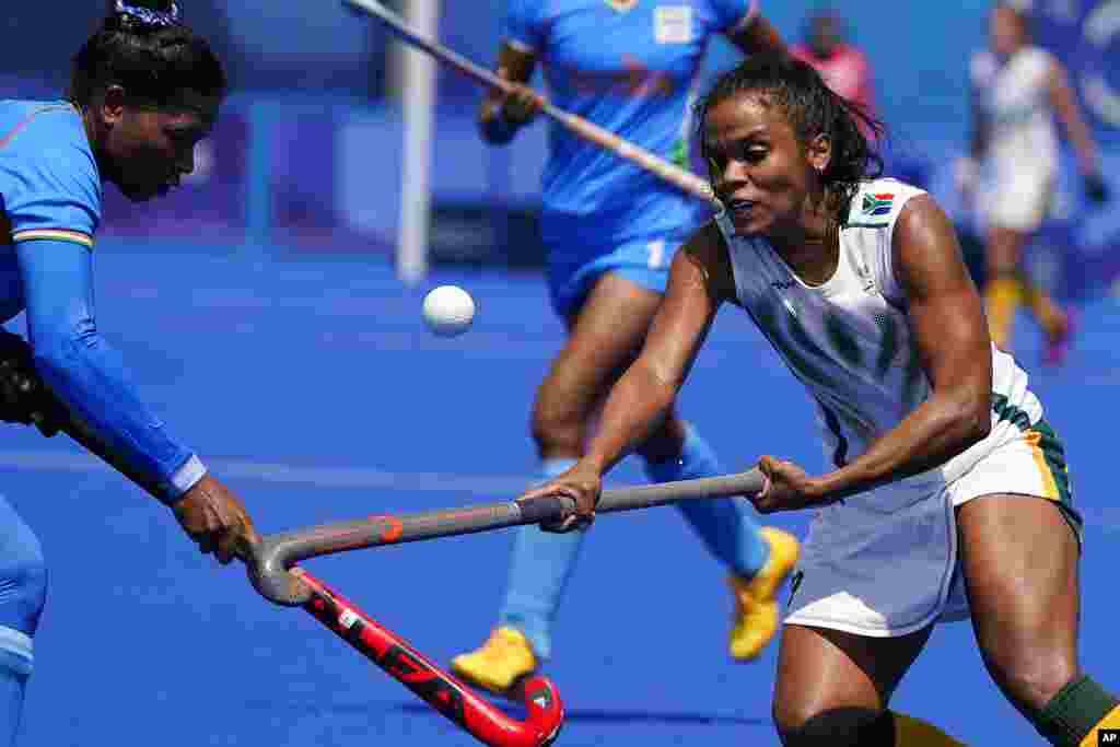 South Africa's Toni Marks, right, and India defender Deep Grace Ekka (3) battle for the ball during a women's field hockey match at the 2020 Summer Olympics, Saturday, July 31, 2021, in Tokyo, Japan. (AP Photo/John Locher)