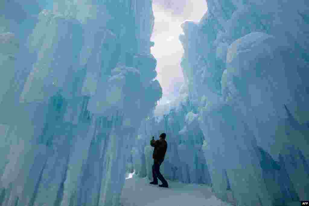 A person treks through the caverns and snow at Ice Castles in North Woodstock, New Hampshire, Feb. 8, 2025.