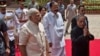 Indian President Pranab Mukherjee (R) arrives with Indian Prime Minster Narendra Modi (L) to address the joint session of Parliament in New Delhi, India, June 9, 2014. 