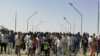 FILE: Sudanese demonstrators march and chant during a protest against the military takeover, in Atbara, Sudan, Oct. 27, 2021 in this social media image.