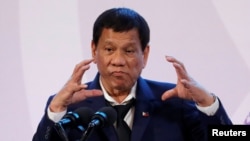 FILE - Philippines' President Rodrigo Duterte gestures during a news conference on the sidelines of the Association of South East Asian Nations summit in Pasay, metro Manila, Philippines, Nov. 14, 2017. Duterte has ended peace talks with Maoist-led rebels
