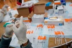 In this April 8, 2021, file photo, a Northwell Health registered nurses fills a syringe with the Johnson & Johnson COVID-19 vaccine at a pop up vaccination site at the Albanian Islamic Cultural Center in the Staten Island borough of New York.