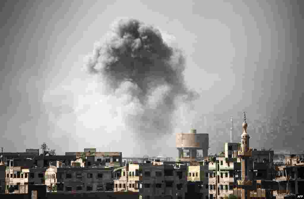 Smoke billows from buildings following a reported airstrike on Ain Tarma in the Eastern Ghouta area, a rebel stronghold east of the Syrian capital.