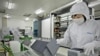 FILE - A worker sorts silicon wafers at the manufacturing center of solar cell maker Trina Solar in Changzhou, China. Trina now has a facility in the Hofusan Industrial Park, about 20 km north of Monterrey, Mexico, not far from the border with Texas.