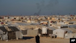 A woman walks in the al-Hol camp in northeastern Syria's Hasakeh province, where tens of thousands of mostly women and children linked to the Islamic State group have been living for years, Jan. 30, 2025.