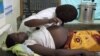 FILE - A health care worker attends to a pregnant woman in Mbale district, eastern Uganda, Sept. 27, 2011.