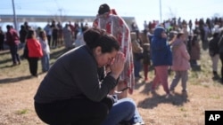 Dasia Pleitez prays as she waits for her daughter at a unification site following a shooting at the Antioch High School in Nashville, Tennessee, Jan. 22, 2025.