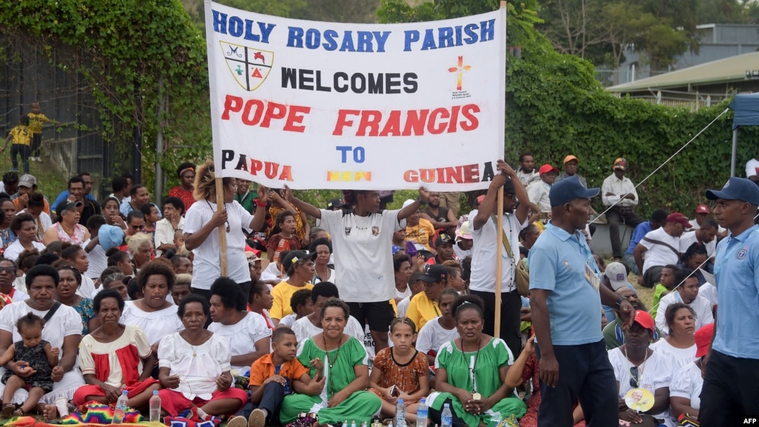 Peopel wait for the arrival of Pope Francis outside the Port Moresby International airport on Sept. 6, 2024.