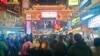 People wear face masks to protect against the spread of the coronavirus at a night market during the Lunar New Year celebrations in Taipei, Jan. 25, 2023.