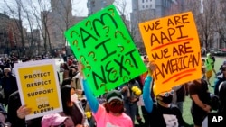 FILE - People take part in a rally against hate and confront the rising violence against Asian Americans at Columbus Park in New York's Chinatown on March 21, 2021.
