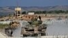 Members of the Hayat Tahrir al-Sham (HTS) jihadist group bring reinforcements on the outskirts of the Afrin region of Syria's rebel-held northern Aleppo province, Oct. 13, 2022.