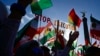 FILE - Protesters hold up a placard reading "Stop Execution in Iran" at a rally in Berlin, Oct. 22, 2022. Britain has joined the effort targeting the death penalty in Iran, with more then 250 members of the U.K. Parliament condemning the practice.