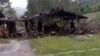 Puing-puing berserakan di sekitar bangunan kayu yang hancur di dekat Desa Aung Bar Lay, kotapraja Hpakant, negara bagian Kachin di Myanmar Senin, 24 Oktober 2022. ( AP)