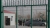 FILE - Residents line up inside the Artux City Vocational Skills Education Training Service Center, which was revealed by leaked documents to be a forced indoctrination camp at the Kunshan Industrial Park in Artux in western China's Xinjiang region, Dec. 3, 2018.