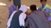 This screenshot of a video sent to VOA Persian appears to show residents of southeast Iran's Zahedan city tending to a wounded man after police shot at protesters on Sept. 30, 2022. (UGC)