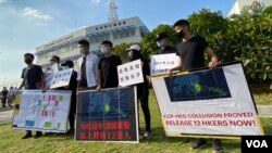 前香港眾志秘書長黃之鋒(右四)聯同多名抗爭派社運人士及多名被中國逮捕港人家屬,10月8日到飛行服務隊總部外抗議,他們展示據稱是飛行服務隊內部文件,質疑12港人事件是中港當局”勾結送中”。(美國之音湯惠芸拍攝)