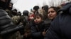 Migrants gather on the Belarusian-Polish border in an attempt to cross it in the Grodno region, Belarus, November 11, 2021. (Ramil Nasibulin/BelTA/Handout via Reuters)