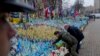 Ukrainian President Volodymyr Zelenskyy, left, and German Chancellor Olaf Scholz attend a ceremony of honoring fallen soldiers near the People's Memorial of National Memory in Kyiv, Dec.2, 2024.