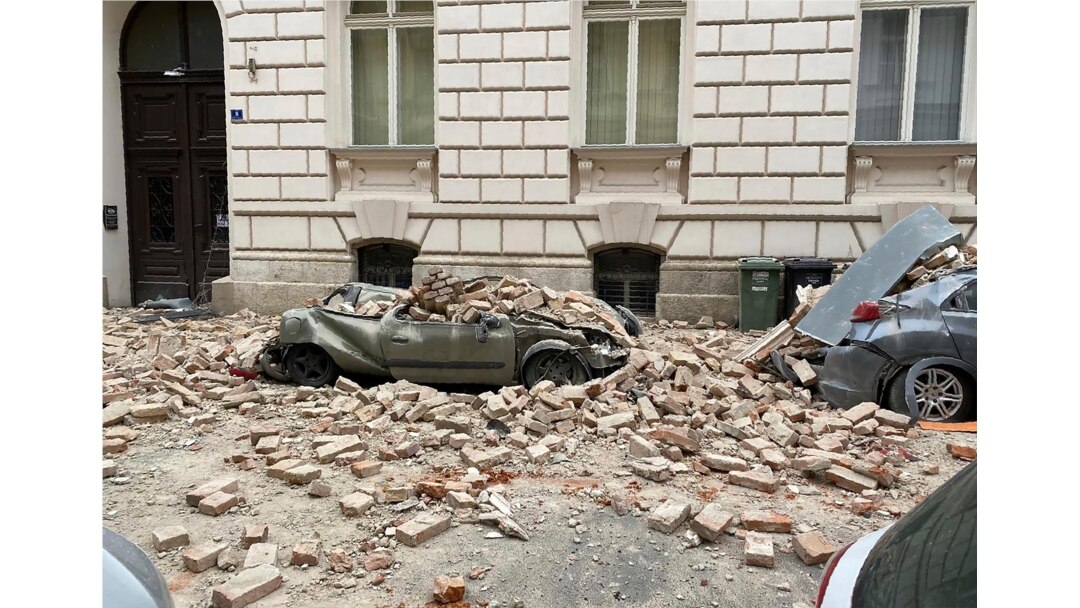 A car is crushed by falling debris after an earthquake in Zagreb, Croatia, March 22, 2020.