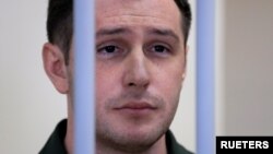 ARHIVA: Bivši američki marinac Trevor Rid iza rešetaka tokom sudskog pretresa u Moskvi, 11. mart 2020.(REUTERS/Tatyana Makeyeva)