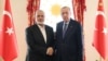 This handout photograph taken and released by Turkish Presidency Press Office on April 20, 2024, shows Turkish President Recep Tayyip Erdogan, right, shaking hands with Ismail Haniyeh, the political leader of Hamas, at the Dolmabahce Presidential working office in Istanbul.