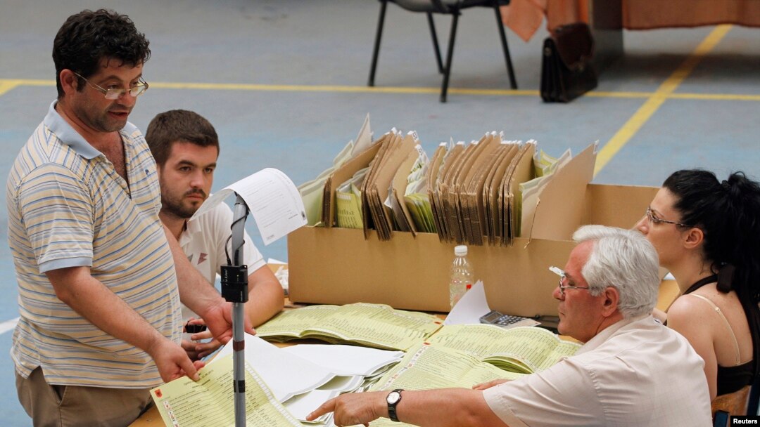 Albanian election officials count votes in Tirana, June 24, 2013.