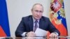 In this picture made available by Sputnik news agency, Russian President Vladimir Putin chairs a meeting with members of the government via a video conference at the Novo-Ogaryovo state residence outside Moscow, Dec. 24, 2021. (Alexey Nikolsky/ Sputnik/AFP)