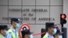 Policemen walk past the U.S. consulate in Chengdu, southwestern China's Sichuan province, on July 26, 2020.