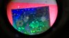 A Chinese microchip is seen through a microscope set up at the booth for the state-controlled Tsinghua Unigroup project which is driving China's semiconductor ambitions during the 21st China Beijing International High-tech Expo in Beijing, China, May 17, 2018.
