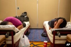 Residents of the Mescalero Apache Reservation rest while sheltering at the Inn of the Mountain Gods Resort in Ruidoso, N.M., Tuesday, June 18, 2024. Thousands have fled their homes as a wildfire swept into Ruidoso in southern New Mexico. (AP Photo/Andres Leighton)