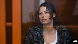 FILE - U.S.-Russian national Ksenia Karelina, also known as Ksenia Khavana, sits in a glass cage in a court room in Yekaterinburg, Russia, June 20, 2024. 