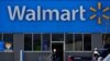 FILE - A woman pushes a shopping cart to enter a Walmart in Rolling Meadows, Ill., Nov. 5, 2020.
