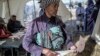 A Basotho woman prepares to cast her ballot, at a polling station on June 3, 2017 in Maseru, during Lesotho's general election.