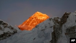 FILE - In this Nov. 12, 2015, file photo, Mt. Everest is seen from the way to Kalapatthar in Nepal. Some climbers attempting to scale Mount Everest during the upcoming spring climbing season will be strapped with a GPS device to locate them in case they are in trouble and to prevent false claims of reaching the summit, officials said Monday. 
