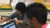 FILE - Students in Fairfax County, Virginia, use their online textbooks in class.