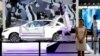FILE - An industrial robot is displayed with car during the China Auto 2018 show in Beijing, China, April 26, 2018. Under President Xi Jinping, a program known as "Made in China 2025" aims to make the country a tech superpower.