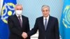 Kazakhstan's President Kassym-Jomart Tokayev, right, shakes hands with the secretary-general of the Collective Security Treaty Organization, Stanislav Zas, prior to their talks in Nur-Sultan, Kazakhstan, Jan. 12, 2022. (Kazakhstan's Presidential Press Service via AP)