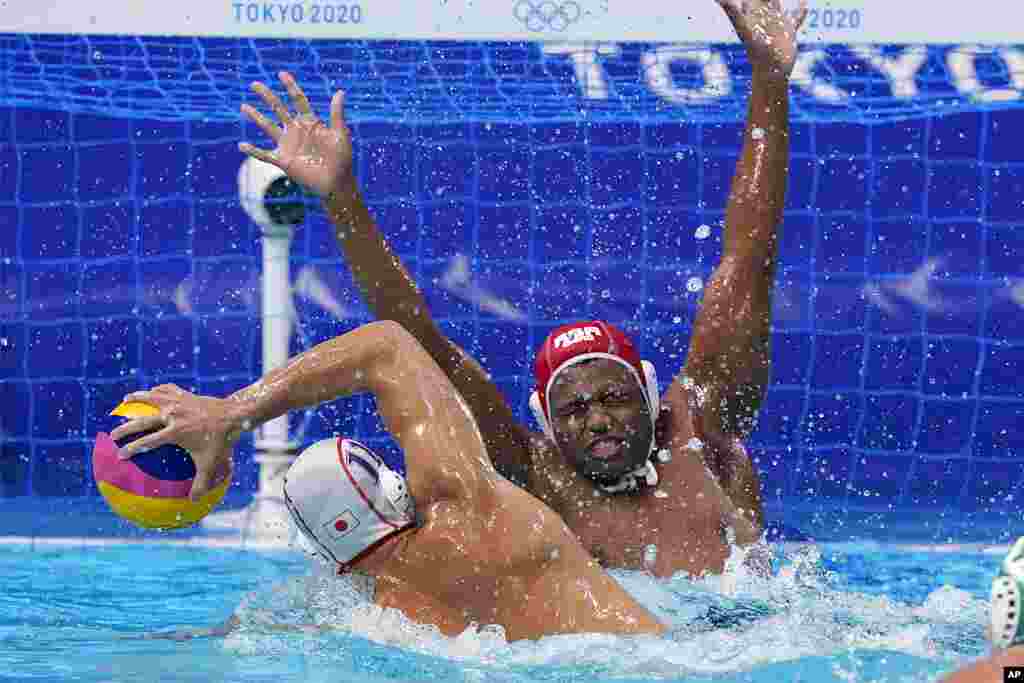 Japan's Keigo Okawa (11) scores a goal against South Africa's goalkeeper Lwazi Madi during a preliminary round men's water polo match at the 2020 Summer Olympics, Monday, Aug. 2, 2021, in Tokyo, Japan. (AP Photo/Mark Humphrey)