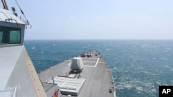 In this photo provided by the U.S. Navy, the Arleigh Burke-class guided-missile destroyer USS Halsey conducts routine underway operations while transiting through the Taiwan Strait on May 8, 2024. 